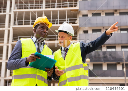 Engineers standing on construction site 110456601
