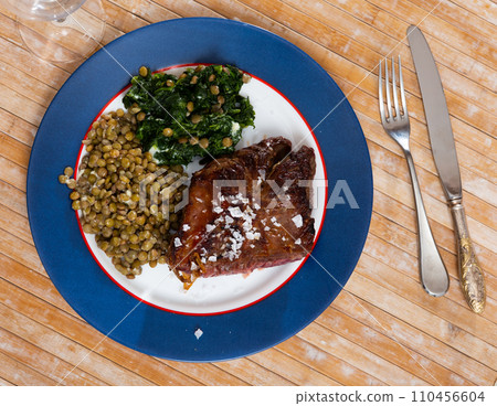 Baked beef loin with green lentils and spinach Baked beef loin with green lentils and spinach 110456604