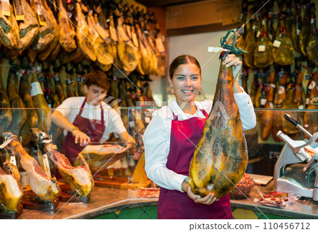 Portrait of positive female jamon seller 110456712