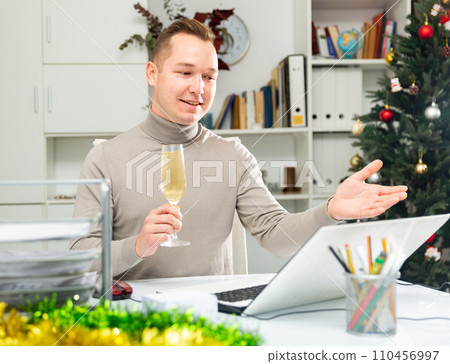 Cheerful man office worker celebrating New Year, having video call 110456997