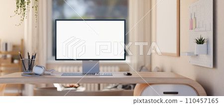 A modern, minimal home workspace in a living room with a white-screen computer mockup on a table. 110457165