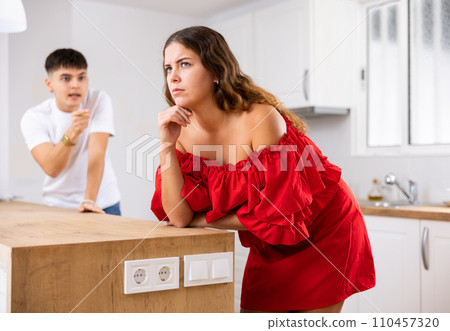 Domestic quarrel of a young family in kitchen Domestic quarrel of a young family in kitchen 110457320