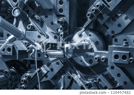 Close up the coil spring machine in light blue scene. 110457482