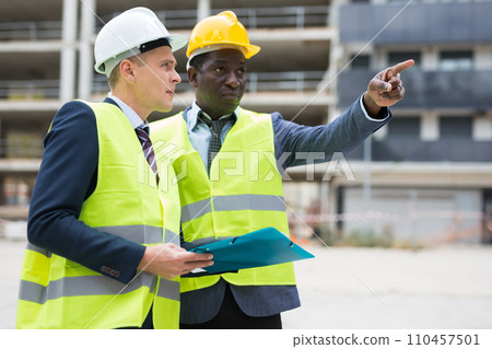 Two architect, civil engineer or building contractor colleagues on construction site Two architect, civil engineer or building contractor colleagues on construction site 110457501