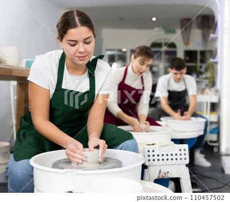 Woman working with pottery wheel Woman working with pottery wheel 110457502