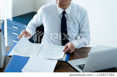 Male businessman checking the ledger 110457764