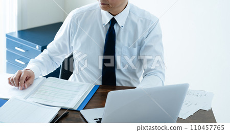 Male businessman checking the ledger 110457765