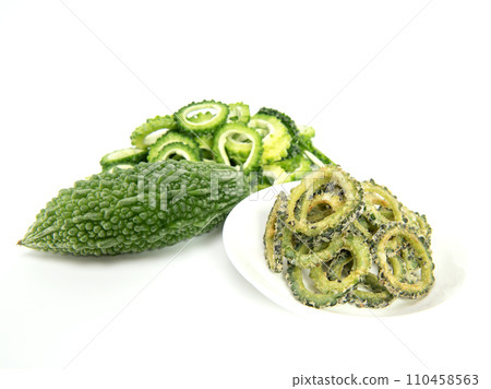 Homemade bitter gourd chips in glass bowl isolated on white background. 110458563