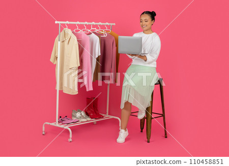 Online Shopping Concept. Happy Asian Woman Using Laptop, Choosing And Buying Clothes 110458851