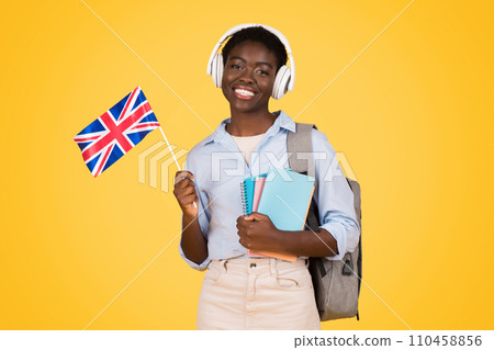 Smiling millennial african american lady student in wireless headphones, with books Smiling millennial african american lady student in wireless headphones, with books 110458856