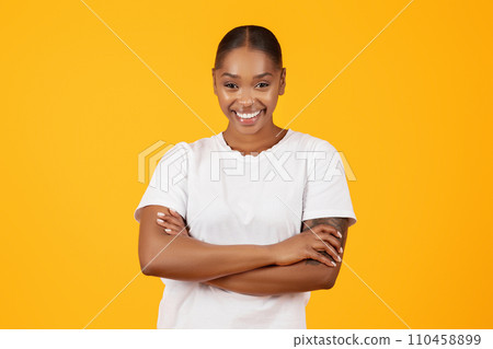 African lady in white t-shirt confidently crossing her hands, studio African lady in white t-shirt confidently crossing her hands, studio 110458899