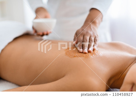 Cropped of lady having skin scrubbing procedure at spa Cropped of lady having skin scrubbing procedure at spa 110458927
