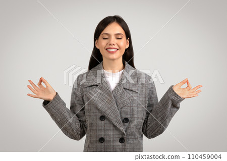 Relaxed woman with eyes closed and palms open meditating Relaxed woman with eyes closed and palms open meditating 110459004