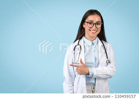 Smiling woman doctor making pointing gesture 110459157