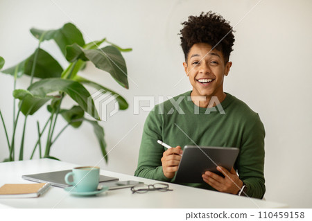 Happy african american guy designer working at cafe Happy african american guy designer working at cafe 110459158