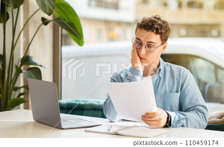 Sad tired confused millennial european guy student manager with laptop, work, study 110459174