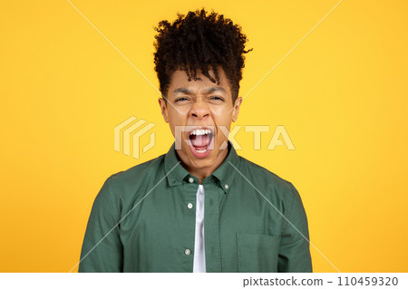 Screaming young african american man standing isolated over yellow background 110459320