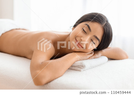 Relaxed young indian woman resting after healing back massage 110459444