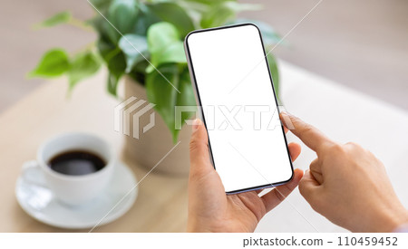 Unrecognizable lady holding phone with blank screen Unrecognizable lady holding phone with blank screen 110459452