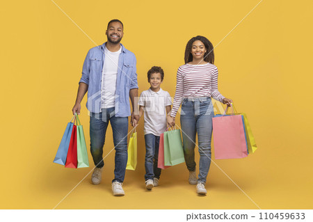 Shopping Day. Cheerful African American Family Of Three Walking With Shopper Bags 110459633