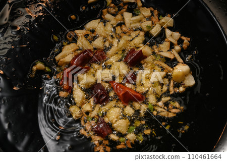 How to fry garlic and chili peppers in olive oil How to fry garlic and chili peppers in olive oil 110461664