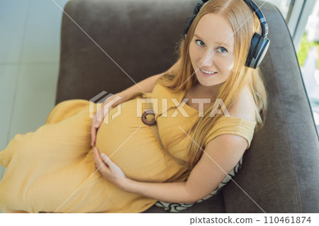 Expectant mom finds joy in her pregnancy, listening to soothing music for a serene and harmonious connection with her unborn baby Expectant mom finds joy in her pregnancy, listening to soothing music for a serene and harmonious connection with her unborn baby 110461874