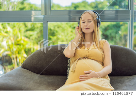 Expectant mom finds joy in her pregnancy, listening to soothing music for a serene and harmonious connection with her unborn baby Expectant mom finds joy in her pregnancy, listening to soothing music for a serene and harmonious connection with her unborn baby 110461877