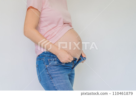 Struggling with jeans. Embrace comfort with maternity wear designed for your growing belly 110461879