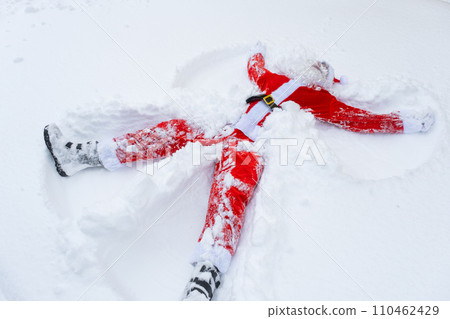 Santa Claus makes snow angels in the snow. Humor, winter fun, Santa is tired and drunk 110462429