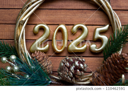Happy New Year golden numbers 2025 on cozy festive brown wooden background with sequins, snow, lights of garlands. Greetings, postcard. Calendar, cover 110462591