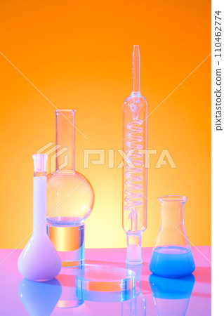 A glass round podium for product display decorated with lab equipments on color gradient background. Front view, science laboratory research and development concept 110462774