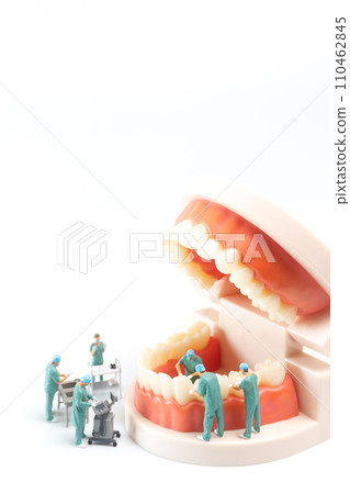 Miniature people , Dentist repairing human teeth with gums and enamel 110462845