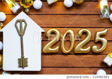 House key with tiny figure of home mock up on festive brown wooden background, lights of garlands. New Year 2025 wooden letters, greeting card. Purchase, construction, relocation, mortgage, insurance House key with tiny figure of home mock up on festive brown wooden background, lights of garlands. New Year 2025 wooden letters, greeting card. Purchase, construction, relocation, mortgage, insurance 110462863
