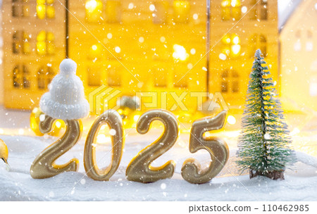 Golden figures number 2025 against the background of cozy windows of a house with warm light with festive decor of stars,snow and garlands. Greeting card, Happy New Year, cozy home 110462985
