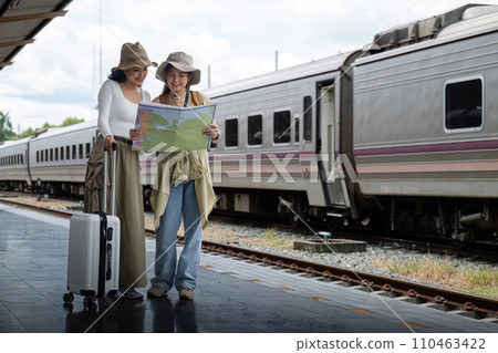 Travel concept. girl friend wear hat holding map have bag and luggage. female traveller waiting train at train station 110463422