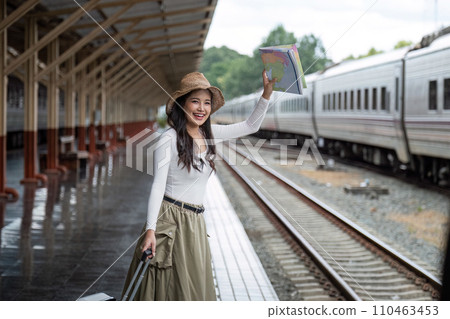 Alone Asian woman traveler with suitcase in train station platform. Summer vacation holiday and travel concept 110463453