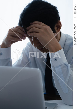 Businessman depressed in front of a computer 110463472
