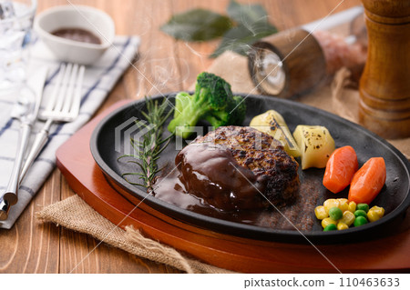 Piping hot hamburger steak finished on a griddle, with plenty of demi-glace sauce Piping hot hamburger steak finished on a griddle, with plenty of demi-glace sauce 110463633