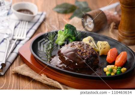 Piping hot hamburger steak finished on a griddle, with plenty of demi-glace sauce Piping hot hamburger steak finished on a griddle, with plenty of demi-glace sauce 110463634
