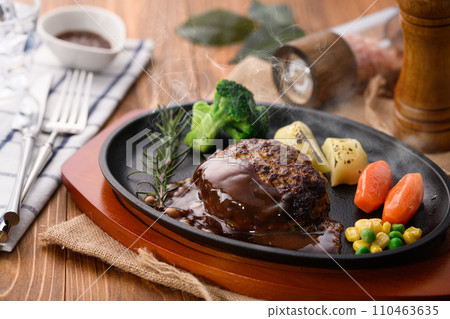 Piping hot hamburger steak finished on a griddle, with plenty of demi-glace sauce Piping hot hamburger steak finished on a griddle, with plenty of demi-glace sauce 110463635