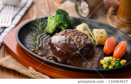Piping hot hamburger steak finished on a griddle, with plenty of demi-glace sauce Piping hot hamburger steak finished on a griddle, with plenty of demi-glace sauce 110463637