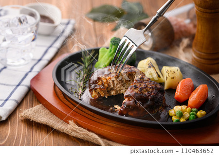 Piping hot hamburger steak finished on a griddle, with plenty of demi-glace sauce Piping hot hamburger steak finished on a griddle, with plenty of demi-glace sauce 110463652