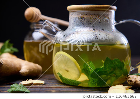 natural organic herbal tea in glass teapot on a wooden table natural organic herbal tea in glass teapot on a wooden table 110463662