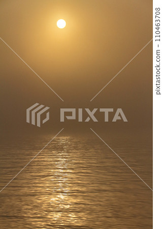 The morning sun has a mystical atmosphere as the sun's light is blocked by the morning mist. The morning sun has a mystical atmosphere as the sun's light is blocked by the morning mist. 110463708