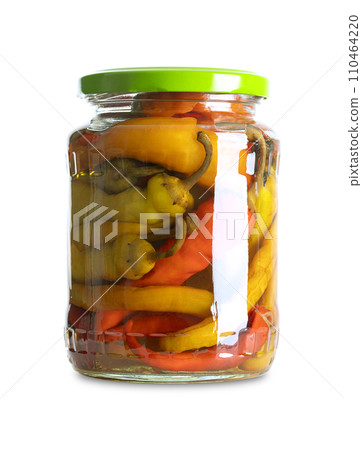 Pepperonis, pickled cayenne peppers in a glass jar. Green, red, and yellow fruits of moderately hot chili peppers, pasteurized and preserved in a brine of vinegar and salt. Close-up, front view. Photo 110464220