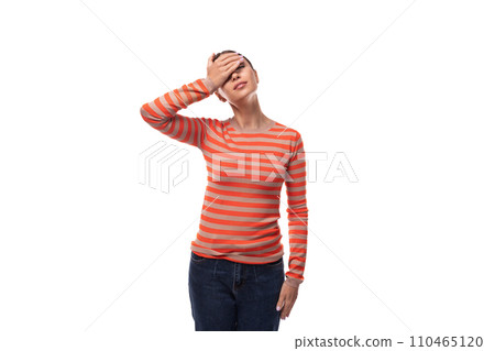 pretty young brunette woman dressed in tight orange sweater feels sad and closed her eyes 110465120