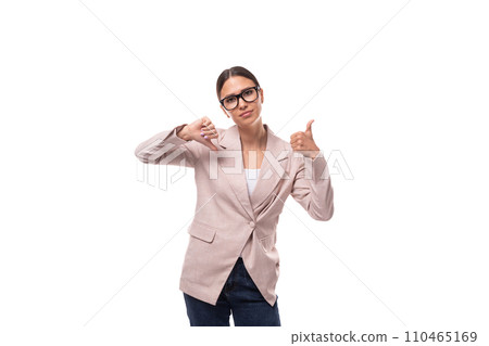 pretty smart young woman with black hair and glasses for vision is dressed in a beige jacket and 110465169