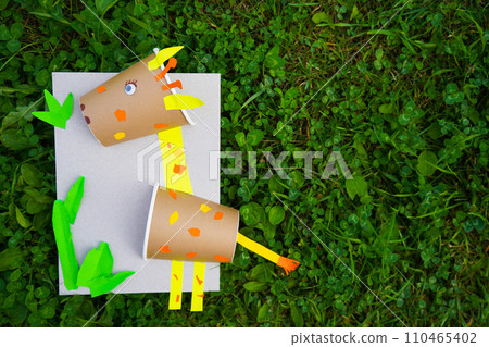 Craft Paper Cup animal cartoon character. DIY Homemade giraffe applique from a paper cup. Kids craft giraffe from a paper coffee cup, zero waste concept. 110465402