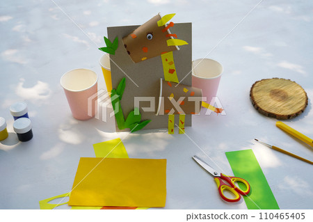 Craft Paper Cup animal cartoon character. DIY Homemade giraffe applique from a paper cup. Kids craft giraffe from a paper coffee cup, zero waste concept. 110465405