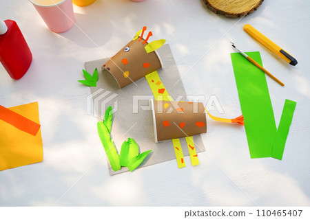 Craft Paper Cup animal cartoon character. DIY Homemade giraffe applique from a paper cup. Kids craft giraffe from a paper coffee cup, zero waste concept. 110465407